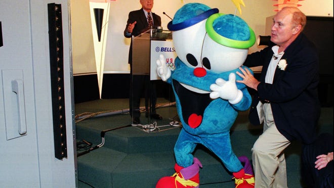 Scott lends a hand to IZZY, the 1996 Atlanta Olympic mascot.
