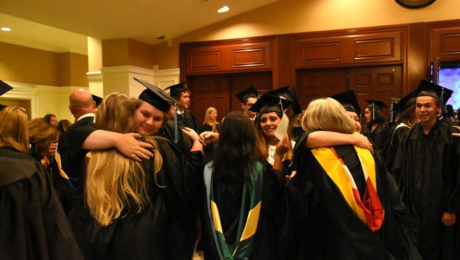 Hugs all around for new grads and their family members. Marco Island Academy graduated its 2018 senior class Friday evening in a ceremony at the Family Church.