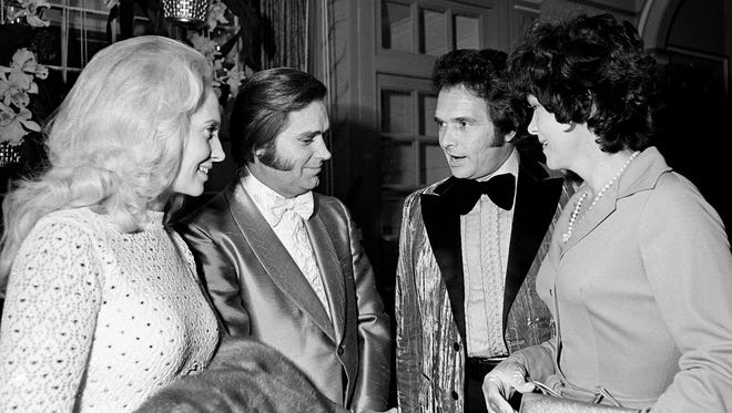 Husband and wife teams take a breather as Tammy Wynette, left, and George Jones chat with Merle Haggard and Bonnie Owens during the BMI Awards banquet at the Belle Meade Country Club on Oct. 16, 1973.