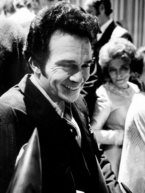 After the end of the telecast of the CMA Awards show at the Grand Ole Opry House on Oct. 14, 1970, Merle Haggard receives congratulations for his four awards.