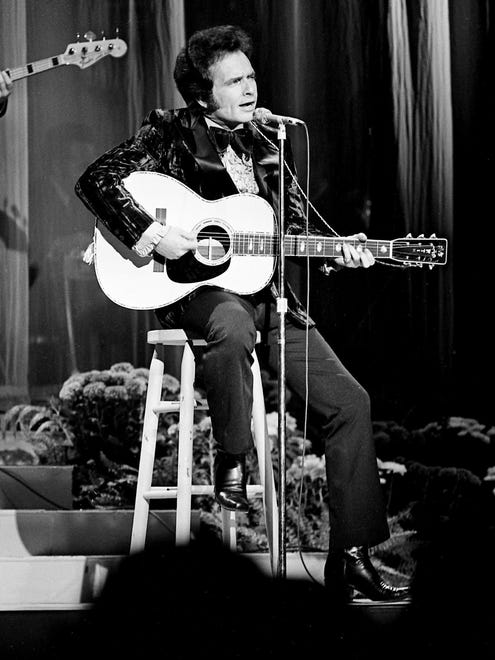 Merle Haggard performs for a packed house at the Grand Ole Opry House during the sixth annual CMA Awards show Oct. 16, 1972.