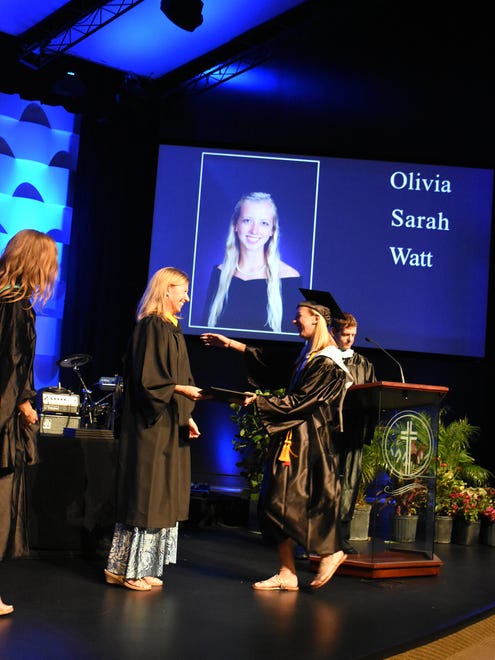 MIA founder and board chair Jane Watt congratulates daughter Olivia as she receives her diploma. Marco Island Academy graduated its 2018 senior class Friday evening in a ceremony at the Family Church.