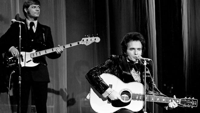 Merle Haggard, right, performs for a packed house at the Grand Ole Opry House during the sixth annual CMA Awards show Oct. 16, 1972.