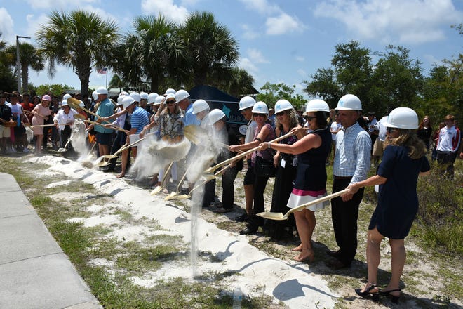 Two dozen people line up for the ceremonial groundbreaking. Marco Island Academy, the island's charter high school, broke ground for phase one of their permanent campus Monday morning, and announced progress in their overall fundraising campaign.