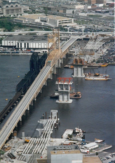 Old Acosta Bridge (April 1991): This aerial view shows the old Acosta Bridge to the left and construction progress on the new span as of April 1991. The view is looking northwest from over the Prudential complex to the Prime Osborn Convention Center in the upper left corner. The plaques were in the portion of the bridge where motorists make a right-hand turn toward downtown.