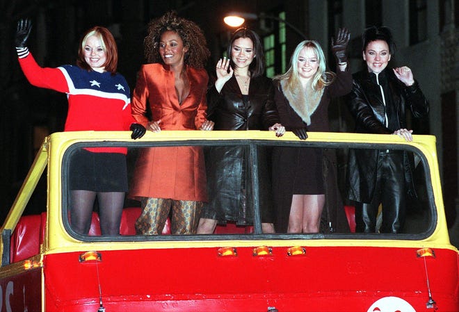 Ginger Spice (Geri Halliwell), Scary Spice (Melanie Brown), Posh Spice (Victoria Adams), Baby Spice (Emma Bunton) and Sporty Spice (Melanie Chrisholm) make a grand appearance in Times Square atop a double decker bus for a screening of their movie "Spice World" at Planet Hollywood in New York on Jan. 14, 1998.