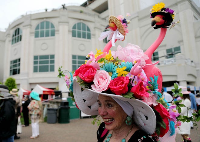 May 4, 2013; Louisville, KY, USA; Jan Beaty walks through the paddock area while wearing a Derby hat before the 2013 Kentucky Derby at Churchill Downs. Mandatory Credit: Jerry Lai-USA TODAY Sports