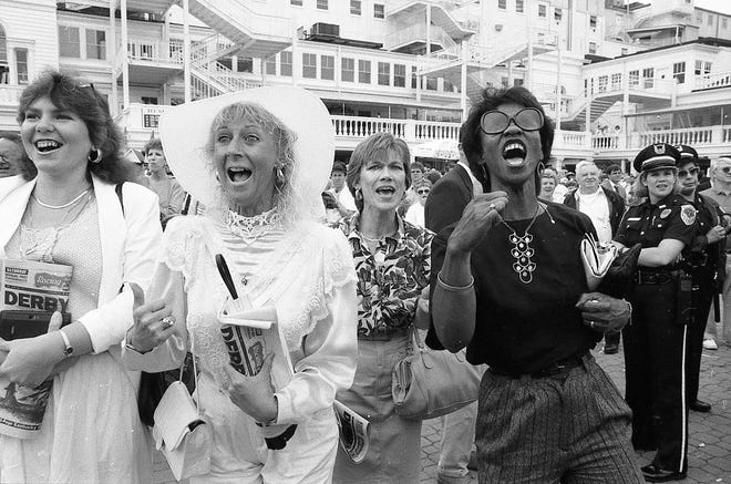 Fans cheer on horses in the paddock at Churchill Downs on Derby Day in 1991