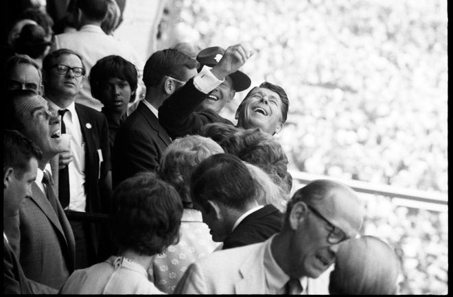 Ronald Reagan, then Governor of California waves to a fan at the Kentucky Derby. Reagan was enjoying the day with President Richard Nixon, on left, looking upward. Reagan went on to become President as well in 1980. May 3, 1969

1969 Reagan Nixon Derby Rs
