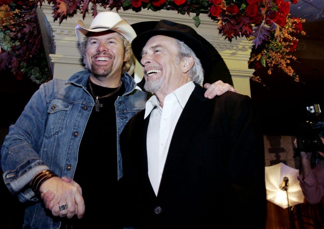 Toby Keith, left, shakes hands with Merle Haggard as they arrive for the 54th annual BMI Country Awards on Nov. 4, 2006.