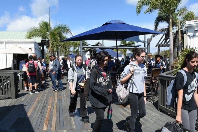 Students head to classes on the rickety wooden deck. Marco Island Academy is embarking on a capital campaign to raise millions of dollars and give the school a permanent home, after years of operating in prefab modules.