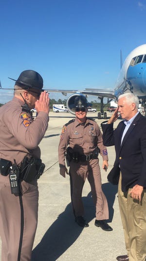 A trooper from the Florida Highway Patrol's Fort Myers' headquarters offers Vice President Mike Pence a salute as he prepares to leave Southwest Florida International Airport on Sunday afternoon. Pence spent the weekend on Sanibel Island.