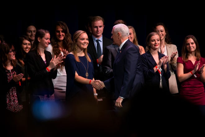 Vice President Mike Pence shakes hands with students as he takes the stage at the O'Bryan Performance Hall in the Thomas and Selby Prince Building at Ave Maria University on Thursday, March 28, 2019.