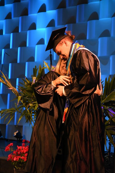 Sean Sorrick receives the Faculty Award and a hug from teacher Lori Galiana. Marco Island Academy held its 2019 commencement ceremony Friday evening at the Family Church.
