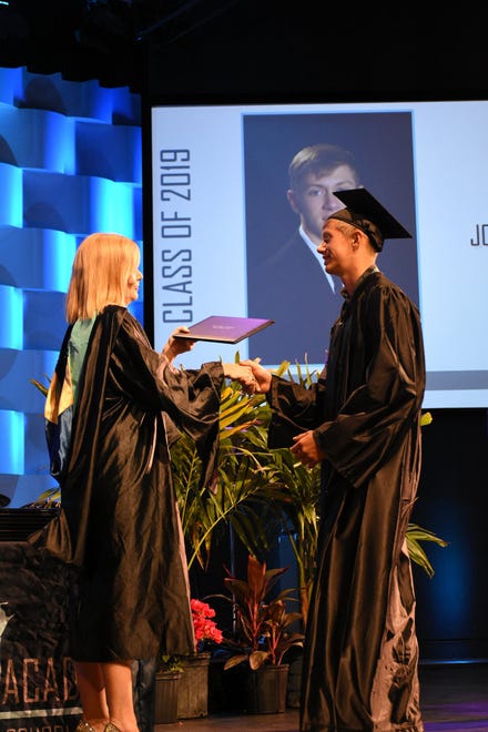 Joseph Golec receives his diploma (and a hug) from Principal Melissa Scott. Marco Island Academy held its 2019 commencement ceremony Friday evening at the Family Church.