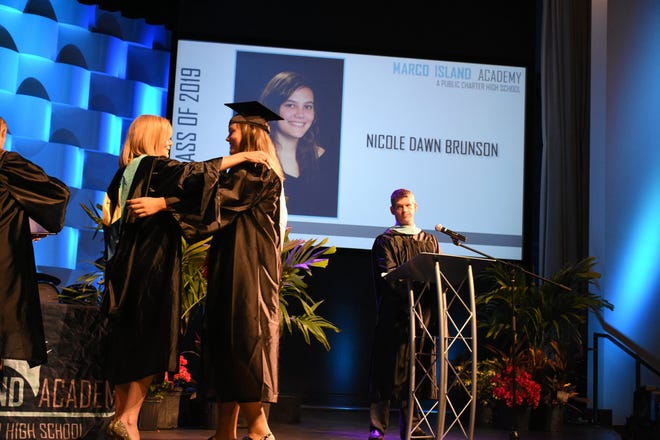 Nicole Brunson receives her diploma and a hug from Principal Melissa Scott. Marco Island Academy held its 2019 commencement ceremony Friday evening at the Family Church.