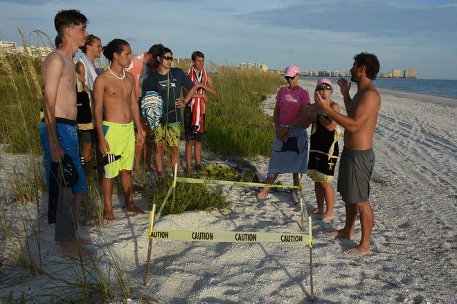 Science teacher Jerry Miller, right, talks about turtle nesting on Tigertail Beach. Marco Island Academy's Ambassadors of the Environment summer camp took middle and high school students around the area to explore our natural surroundings last week.