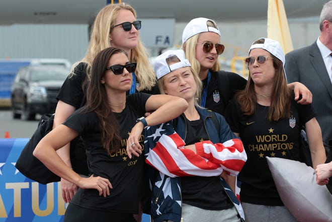 Members of the U.S. Women's National Soccer Team get their bearings after flying home from France.