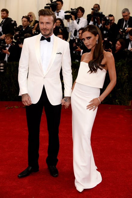 A couple that slays together stays together. Victoria Beckham wore a white gown she'd designed herself while David Beckham wore a complementary white tux at the Met Gala on May 5, 2014.