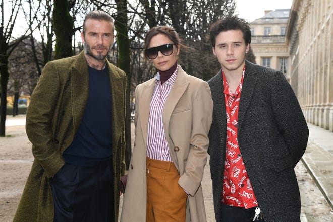 The Beckhams (pictured here with an 18-year-old Brooklyn Beckham) made an outing together during Paris Fashion Week on Jan. 18, 2018.