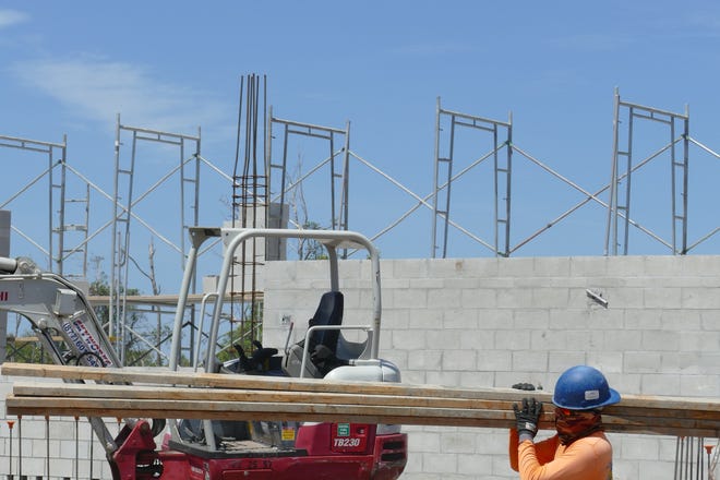 Construction workers build Marco Island Academy's new facilities May 7, 2020.