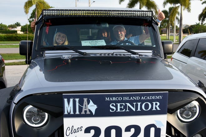 Graduate Susan Linn and father Ron Linn await her turn to "walk." Marco Island Academy, Marco Island's charter high school, held a "drive-in" graduation ceremony for their 47 graduating seniors Friday evening in the parking lot at Veterans' Community Park.