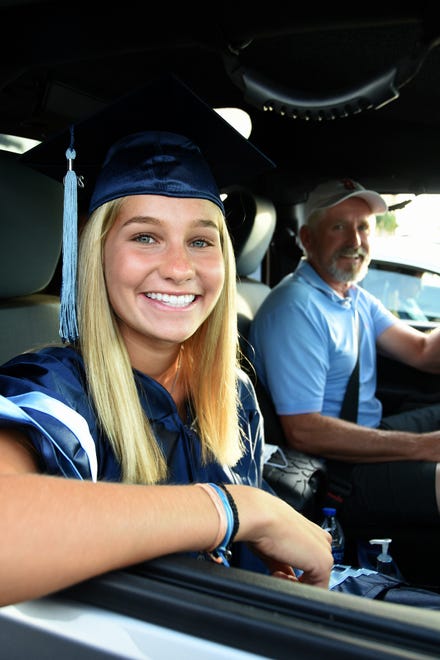 Graduate Susan Linn and father Ron Linn await her turn to "walk." Marco Island Academy, Marco Island's charter high school, held a "drive-in" graduation ceremony for their 47 graduating seniors Friday evening in the parking lot at Veterans' Community Park.
