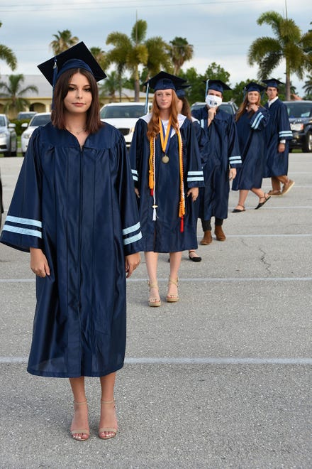 Graduate Savana Baez awaits her turn to "walk." Marco Island Academy, Marco Island's charter high school, held a "drive-in" graduation ceremony for their 47 graduating seniors Friday evening in the parking lot at Veterans' Community Park.