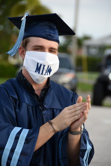 Graduate James Cameron awaits his turn to receive his diploma. Marco Island Academy, Marco Island's charter high school, held a "drive-in" graduation ceremony for their 47 graduating seniors Friday evening in the parking lot at Veterans' Community Park.