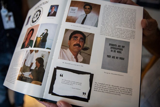 George Abounader shows a picture of himself in a Class of 1999 St. John Neumann Catholic High School yearbook, Friday, July 17, 2020, at his home in Marco Island.
