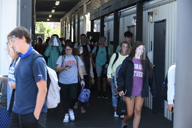 Students exit the school after classes on Tuesday. Marco Island Academy, the island's charter high school, opened its doors to students on Wednesday, August 12.
