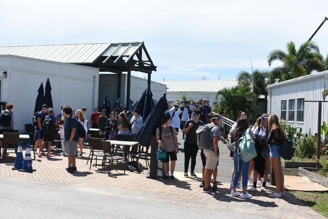 Students wait for their rides after classes on Tuesday. Marco Island Academy, the island's charter high school, opened its doors to students on Wednesday, August 12.