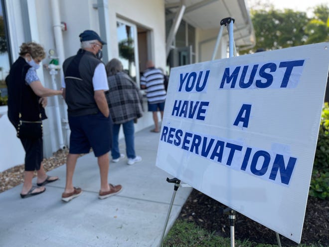 Hundreds of Floridians went to Marco Island's Mackle Park on Friday to get the first dose of the COVID-19 vaccine after making appointments online earlier in the week. In the photo, people register to get the vaccine at Mackle Park on Jan. 29, 2021.