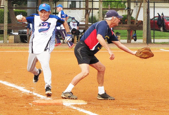Crazy Flamingo's Bill Moors lunges to first base for a base hit beating the throw to American Legion's Al Bozzo.