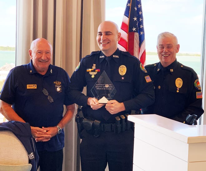 Marco Island Police Department Det. Lorenzo Smith (center) receives his Officer of the Year Award from Police Foundation President Vernon Geberth (left) and Captain Richard Stoltenborg.
