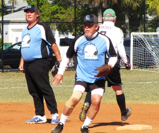 Snook Inn’s Geoff Bentley completes a double play against Stonewalls with shortstop Chris Pickwell looking on.