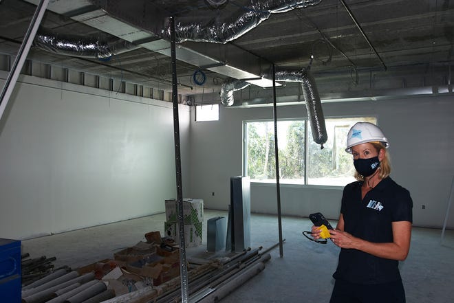 Marco Island Academy founder and board chair Jane Watt shows a visitor one of the classrooms, part of the construction at the new campus on San Marco Blvd. The school is on track to have the gymnasium ready for graduation in May, and the new academic building for the next school year in August.