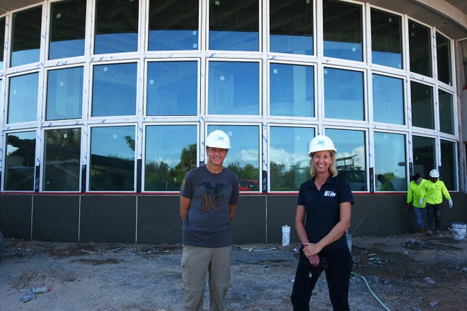 Marco Island Academy founder and board chair Jane Watt and Mark Melvin of the school's leadership advisory board outside the academic building at the new campus on San Marco Blvd. The school is on track to have the gymnasium ready for graduation in May, and the new academic building for the next school year in August.