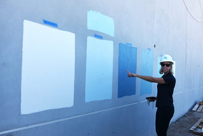 Marco Island Academy founder and board chair Jane Watt points out paint swatches on an exterior wall, part of construction progress at the new campus on San Marco Blvd. The school is on track to have the gymnasium ready for graduation in May, and the new academic building for the next school year in August.