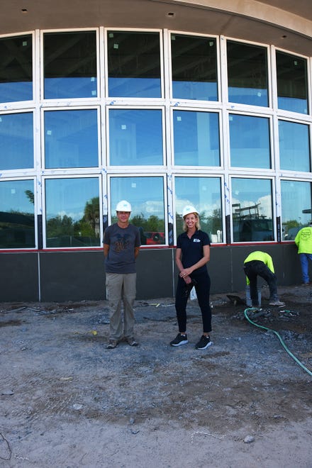 Marco Island Academy founder and board chair Jane Watt and Mark Melvin of the school's leadership advisory board outside the academic building at the new campus on San Marco Blvd. The school is on track to have the gymnasium ready for graduation in May, and the new academic building for the next school year in August.