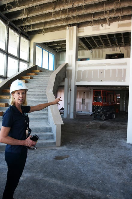 Marco Island Academy founder and board chair Jane Watt shows off the lobby, part of the construction at the new campus on San Marco Blvd. The school is on track to have the gymnasium ready for graduation in May, and the new academic building for the next school year in August.