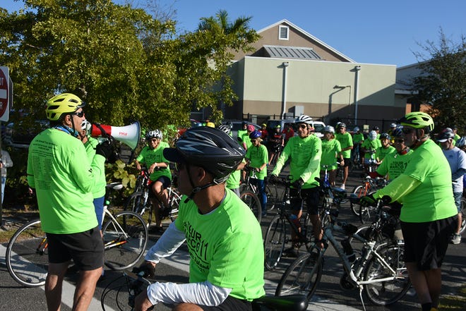 George Abounader addresses the riders before the 15-mile group heads out. The 11th Tour de Marco saw hundreds of cyclists riding 15 or 30 miles around the island on Sunday morning to benefit the YMCA.