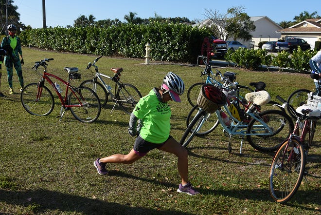 Monica Cobuzio gets in pre-run stretches. The 11th Tour de Marco saw hundreds of cyclists riding 15 or 30 miles around the island on Sunday morning to benefit the YMCA.