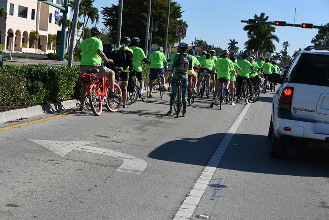The group makes the left turn toward "Olde" Marco. The 11th Tour de Marco saw hundreds of cyclists riding 15 or 30 miles around the island on Sunday morning to benefit the YMCA.