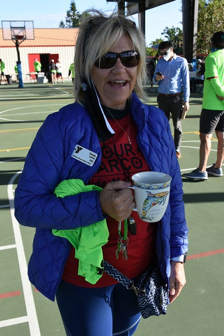 YMCA CEO Cindy Love tries to keep warm before the run. The 11th Tour de Marco saw hundreds of cyclists riding 15 or 30 miles around the island on Sunday morning to benefit the YMCA.
