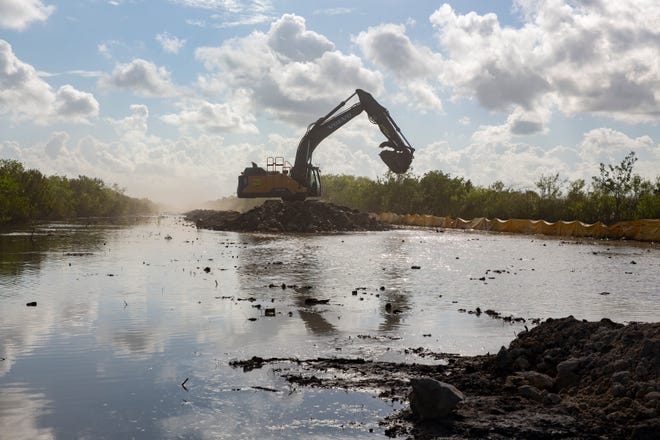 An excavator removes roadbed from Old Tamiami Trail, west of Miami on Tuesday, March 30, 2021. Florida Gov. Ron DeSantis and environmental officials attended a media event to highlight the Comprehensive Everglades Restoration Plan, which includes the removal of five miles of roadbed from Old Tamiami Trail to help facilitate water flow back into the Everglades.