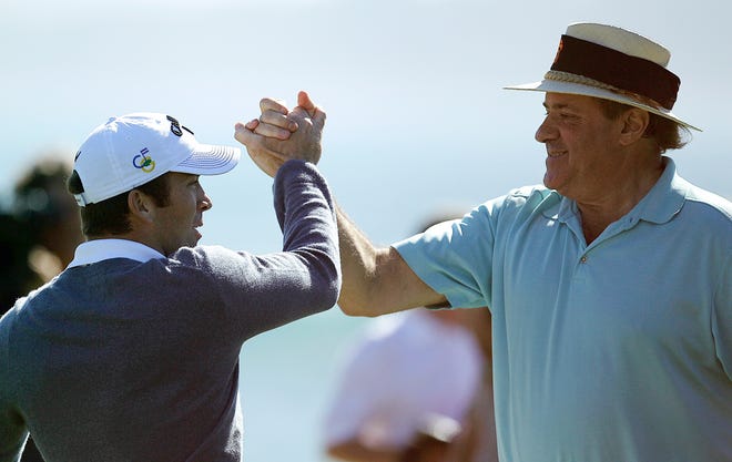 Actor Lucas Black, left, celebrates with partner Chris Berman after making a chip shot to win the celebrity challenge at the Pebble Beach National Pro-Am golf tournament on Wednesday, Feb. 8, 2012, in Pebble Beach, Calif. (AP Photo/Ben Margot)