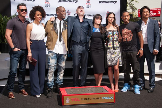Lucas Black, from left, Nathalie Emmanuel, Tyrese Gibson, Vin Diesel, Michelle Rodriguez, Jordana Brewster, Ludacris and Tatchakorn Yeerum attend the Vin Diesel Hand And Footprint Ceremony in the courtyard of the TCL Chinese Theatre on Wednesday, April 1, 2015, in Los Angeles. (Photo by Richard Shotwell/Invision/AP)