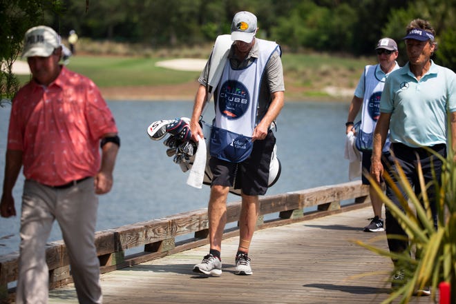 Billy Poore, center, caddies for Gene Sauers, left, during day two of the Chubb Classic at Tiburón Golf Club in North Naples on Saturday, April 17, 2021. Poore was knocked off of a bridge on Friday after being struck by a golf cart driven by Jesper Parnevik.