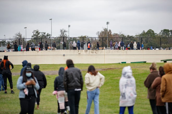 Hundreds of people wait in line to be tested for COVID-19 at the Florida A&M University testing site Monday, Jan. 3, 2022.